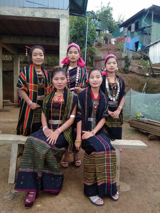 Group of Khongso women wearing traditional attire in a village setting